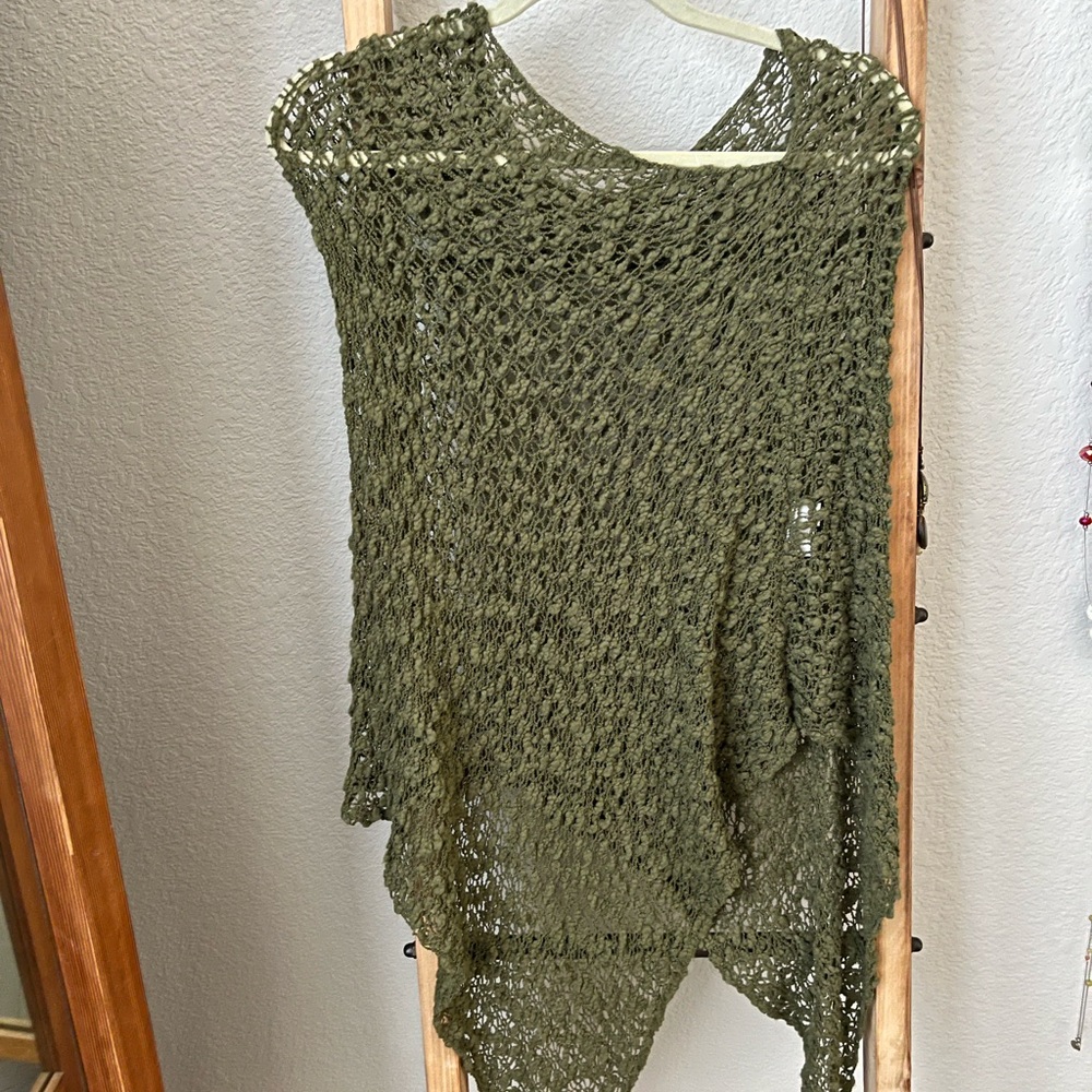 Hunter green shawl over head. Sits on shoulders.
